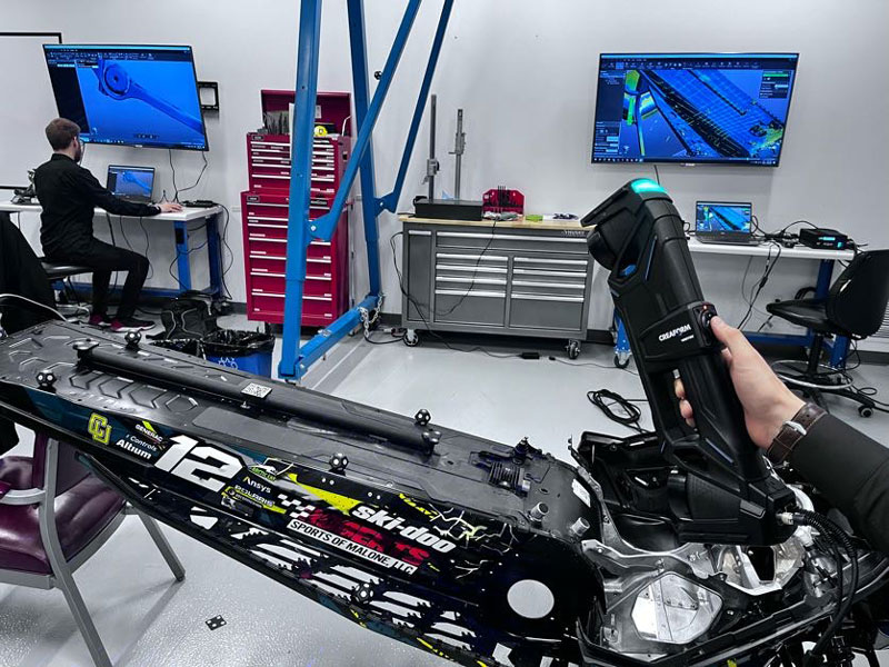 A close-up of the HandySCAN MAX™|Elite metrology-grade 3D scanner as a student scans a large-sized snowmobile part.