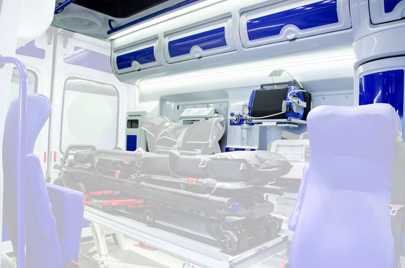 Interior of an ambulance with custom white and blue storage cabinets
