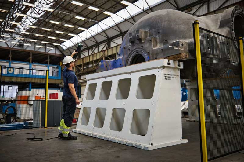 Technician scanning the outer casing of a high-pressure steam turbine with the HandySCAN 3D|MAX Series.