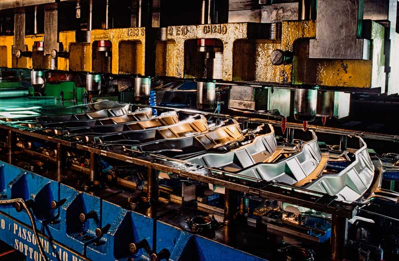 An industrial press with several stamped sheet metal bumpers