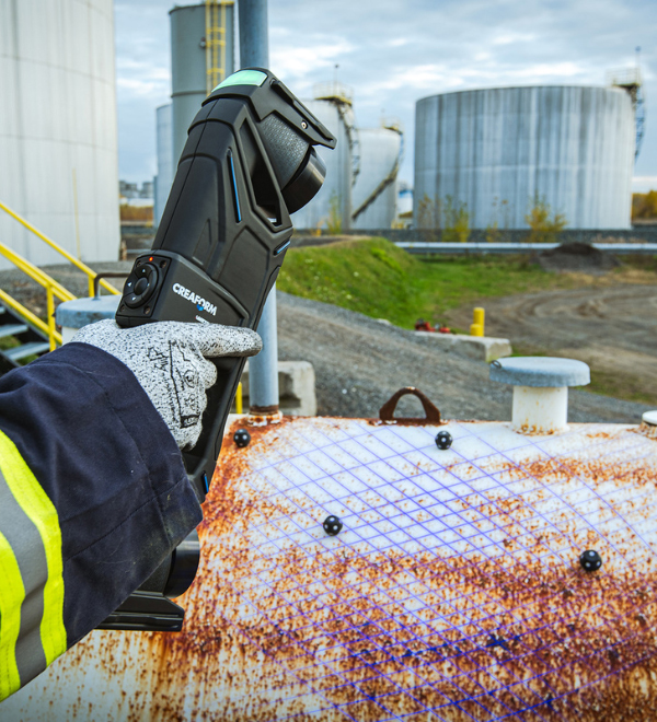 Someone scanning a pressure vessel for monitoring with a Creaform scanner
