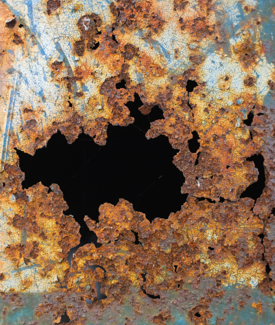 Damge on an old steel tank with holes due to rust