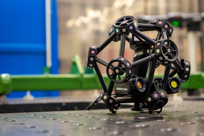 Creaform MetraSCAN 3D placed on a table in an industrial environment.